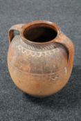 A 20th century terracotta twin handled pot