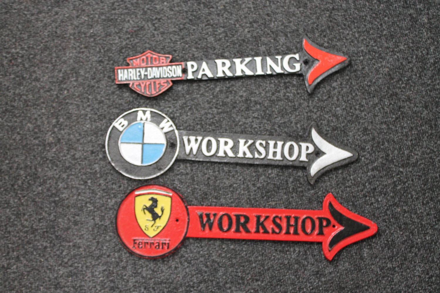 Three cast iron arrows - BMW workshop,