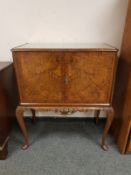 A walnut Queen Anne style cocktail cabinet,