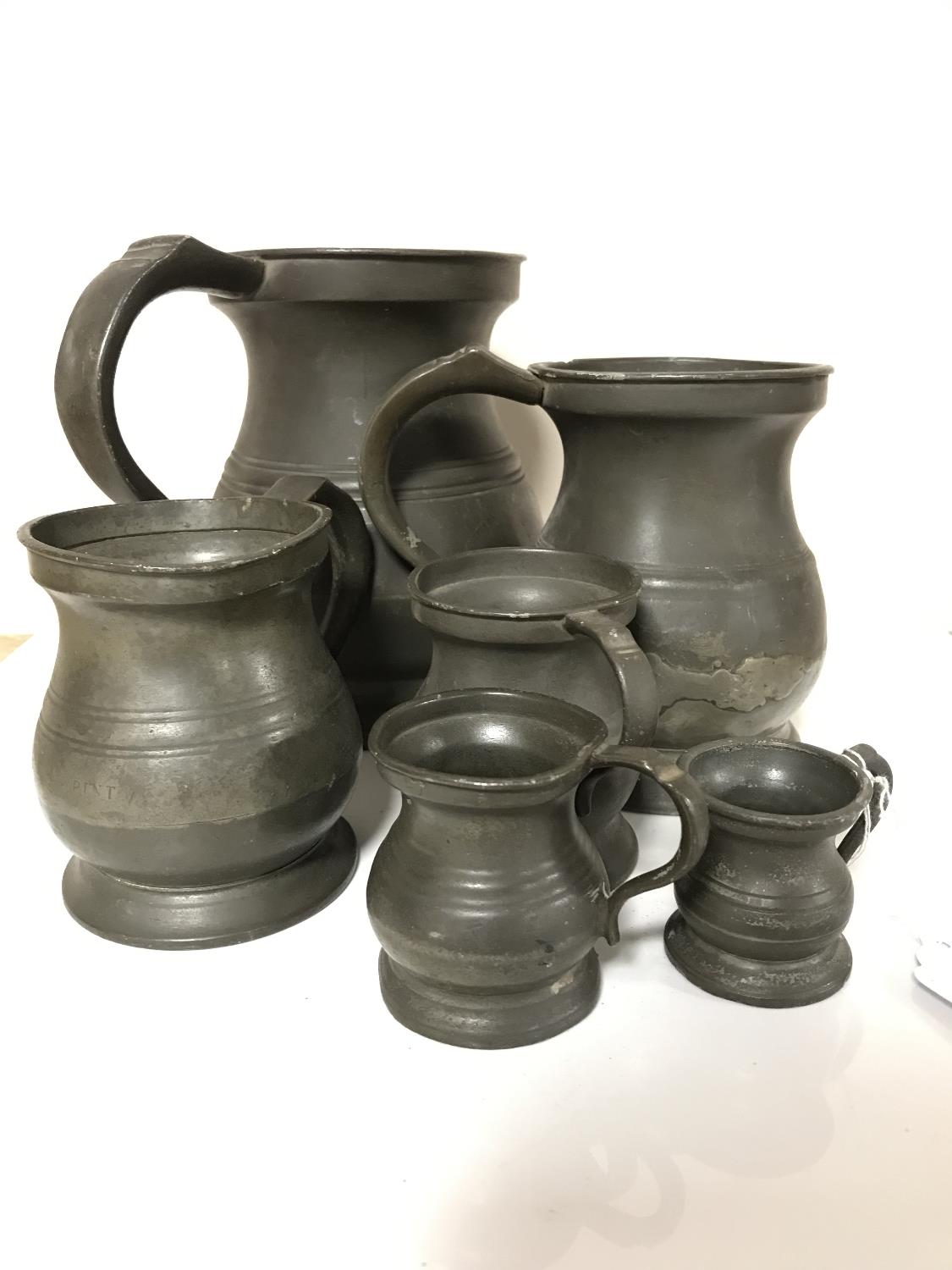 A set of six antique pewter tankards