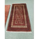 A Persian rug on red geometric ground,