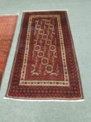 A Persian rug on red geometric ground,