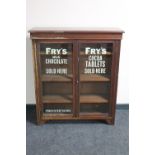 An Edwardian mahogany display cabinet bearing advertising