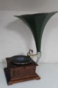 A reproduction HMV table gramophone with horn