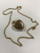 A 9ct gold heart locket on yellow metal chain, 8g.