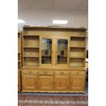 A set of blond oak open bookshelves fitted with cupboard beneath CONDITION REPORT:
