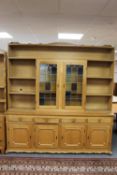 A set of blond oak open bookshelves fitted with cupboard beneath CONDITION REPORT:
