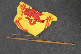 An archery longbow and arrow together with a Scottish flag