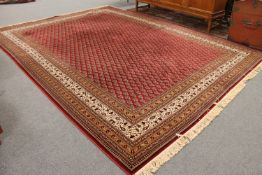 A machine made Turkish carpet on red ground,