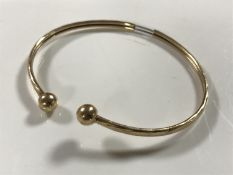 A 9ct gold sleeved expansion bangle