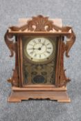 An antique pine cased American mantel clock by the Thomas Clock Company of America