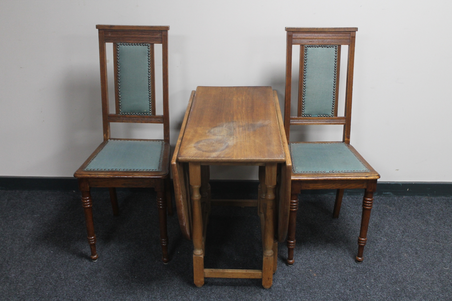 A pair of early 20th century oak high back dining chairs and gate leg table