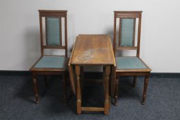 A pair of early 20th century oak high back dining chairs and gate leg table