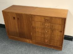 A mid twentieth century Danish teak double door cabinet with matching five drawer chest