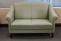 A twentieth century two seater settee upholstered in turquoise fabric