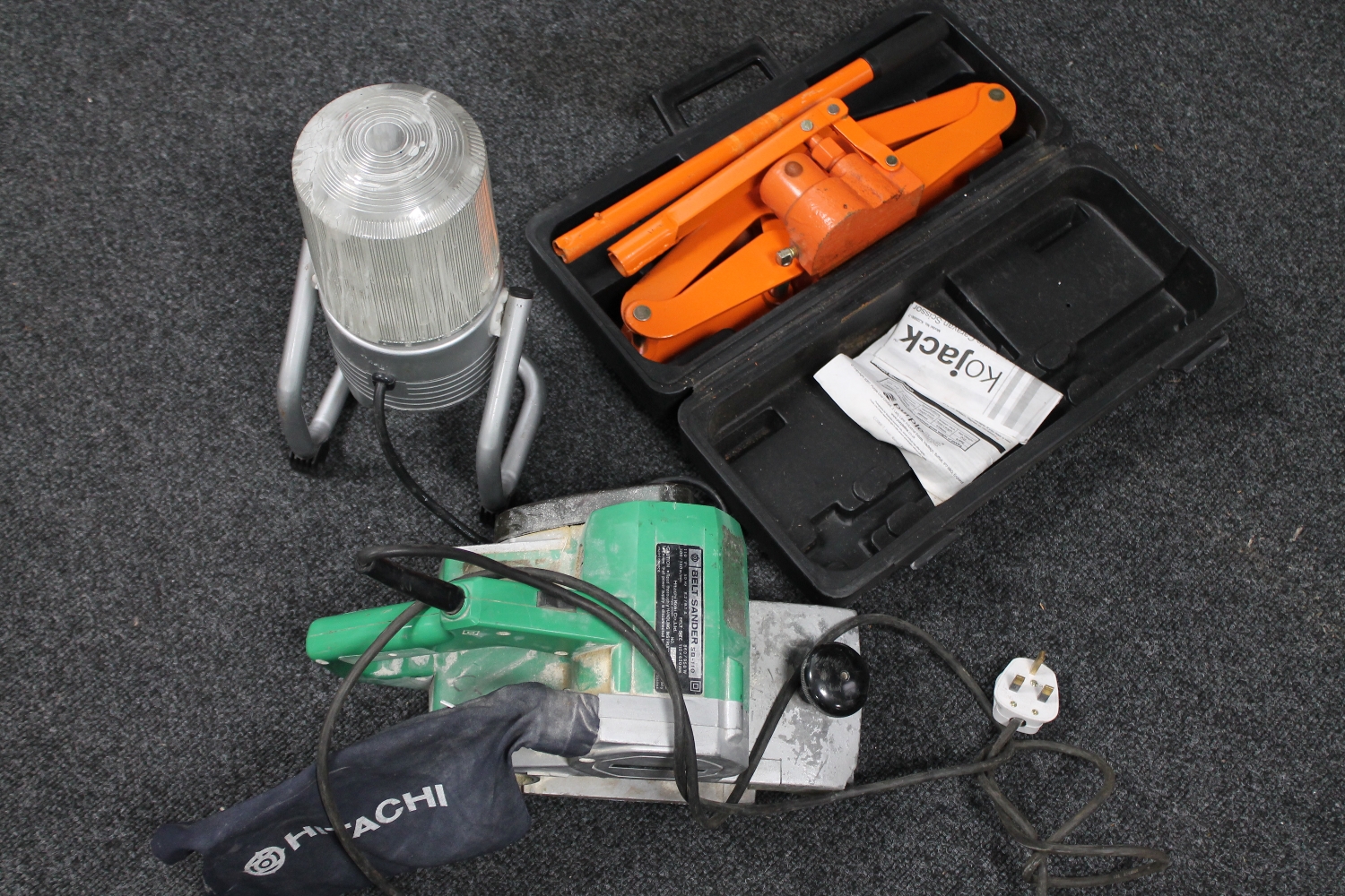 A box of Hitachi SB 110 belt sander,