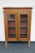 A continental mahogany double door bookcase