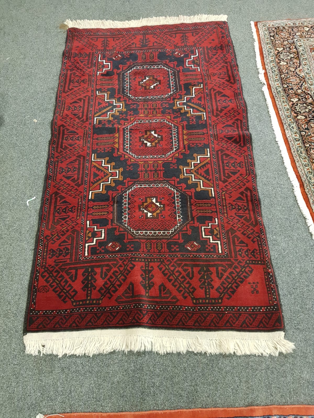 An Eastern rug on red ground,
