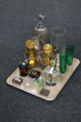 A tray of antique plated two bottle tantalus, assorted glass ware, trinket pots, match book holders,