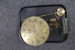 An antique circular brass clock movement by George Green of Leicester with pendulum and two weights