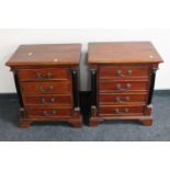 A pair of mahogany four drawer bedside chests with pillar column supports