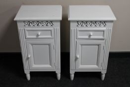 A pair of white bedside cupboards