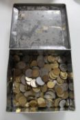 An early 20th century FREARS biscuit tin containing foreign coins