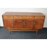 A mid 20th century teak sideboard with drawers above