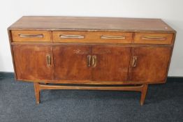 A mid 20th century teak sideboard with drawers above