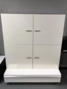 A contemporary high gloss white entertainment stand fitted a drawer and similar four door wall