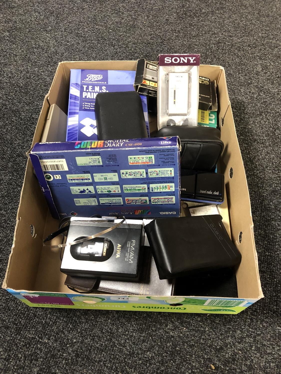 A box of Sony Walkman, Sony FM radio, Casio digital diary, calculators,