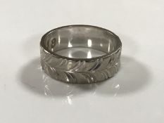 An 18ct white gold textured band ring, 5.2g, size L.