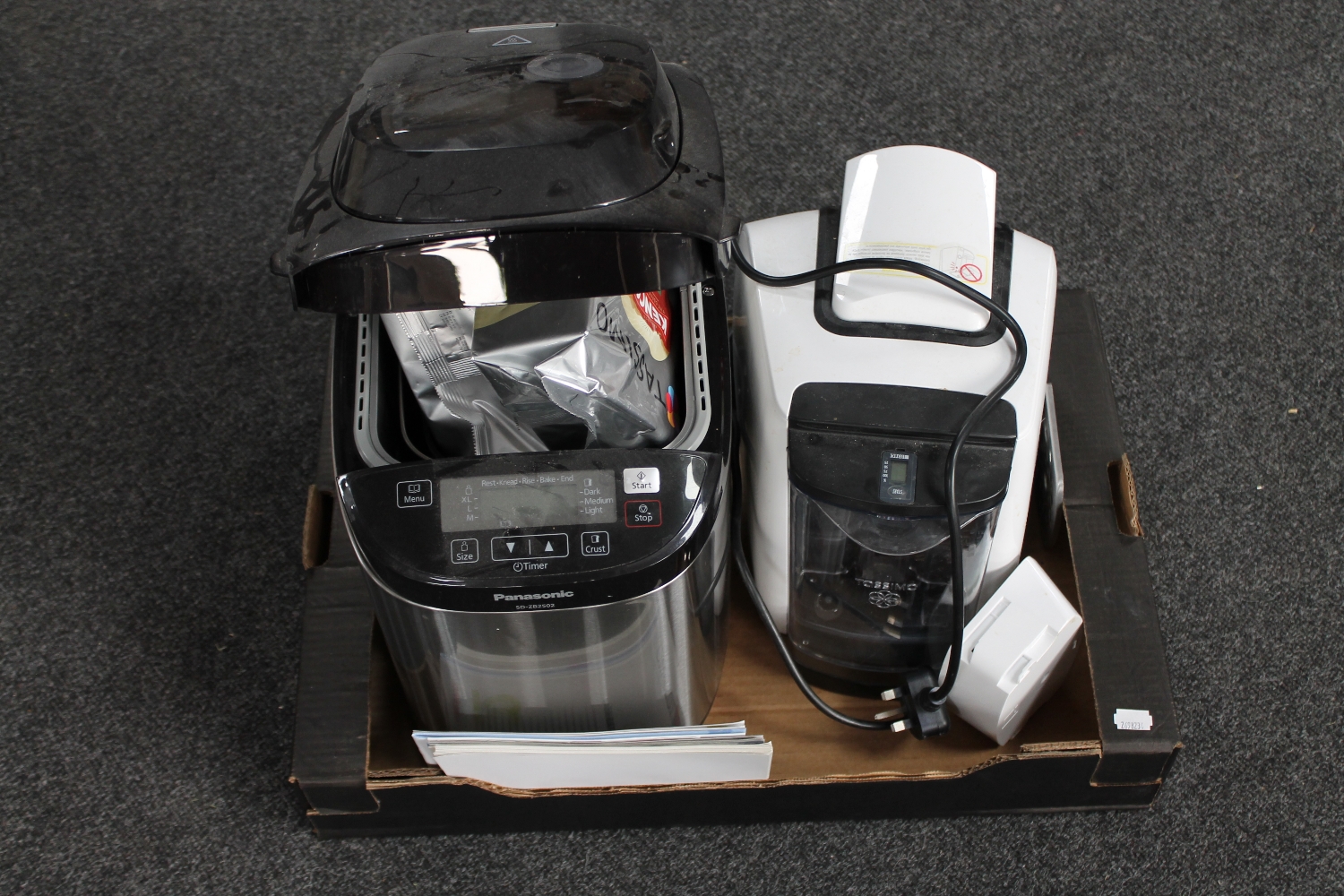 A box of Tassimo coffee maker and a Panasonic bread maker