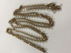 A yellow metal long guard chain, apparently un-marked, 25g.