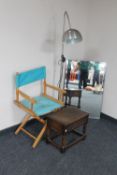 A folding director's chair, un-framed mirror,
