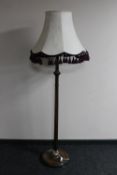 An early 20th century beech standard lamp with tasseled shade