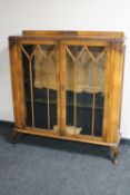 A 1930's walnut display cabinet