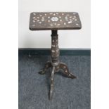 An antique mother of pearl inlaid pedestal table