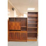 A mid twentieth century wall unit fitted with drawers below together with a set of bookshelves