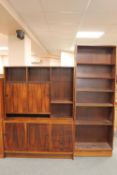 A mid twentieth century wall unit fitted with drawers below together with a set of bookshelves