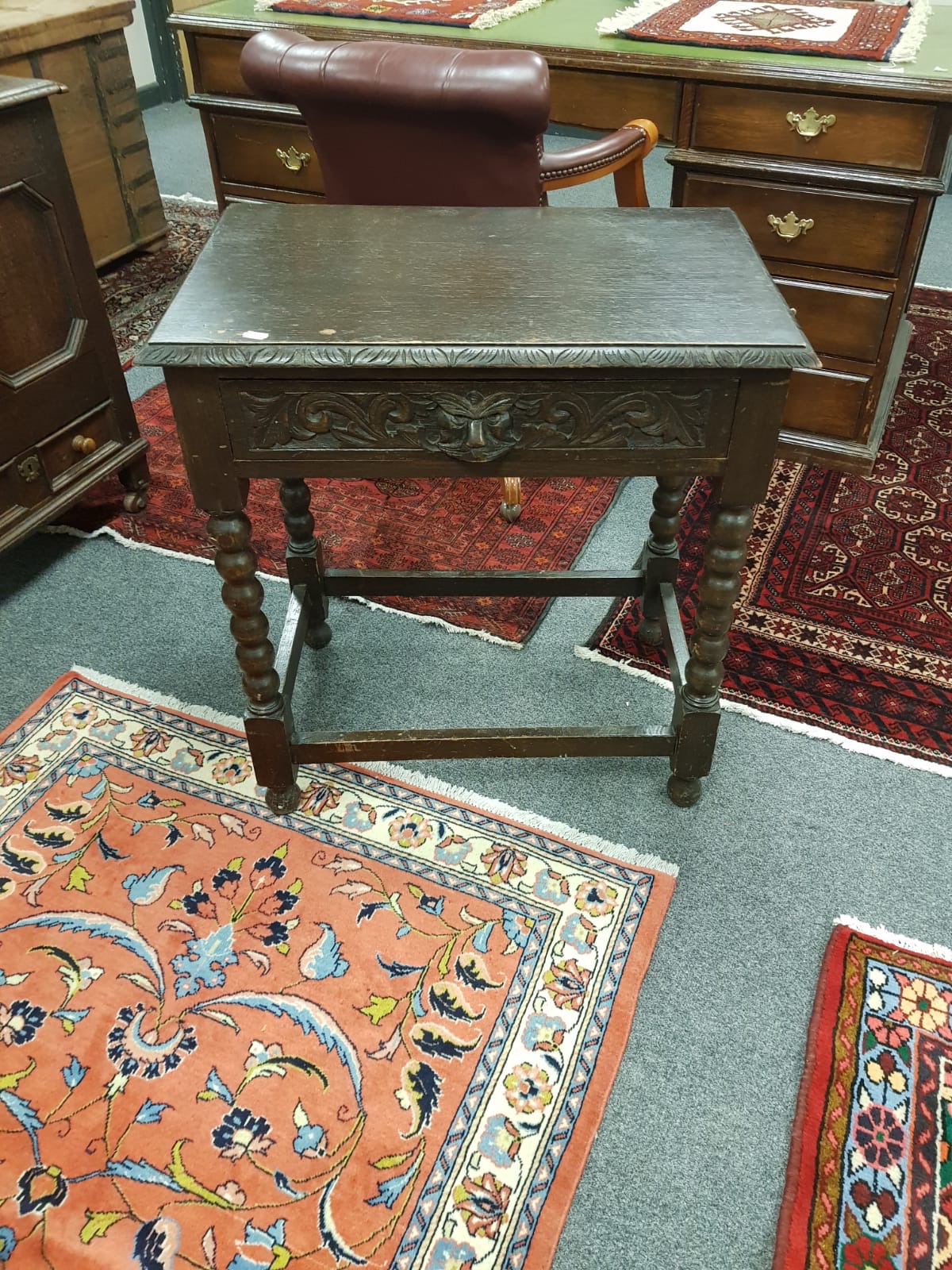 An Edwardian carved oak side table,