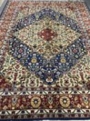 A fringed Persian woolen carpet on blue ground,