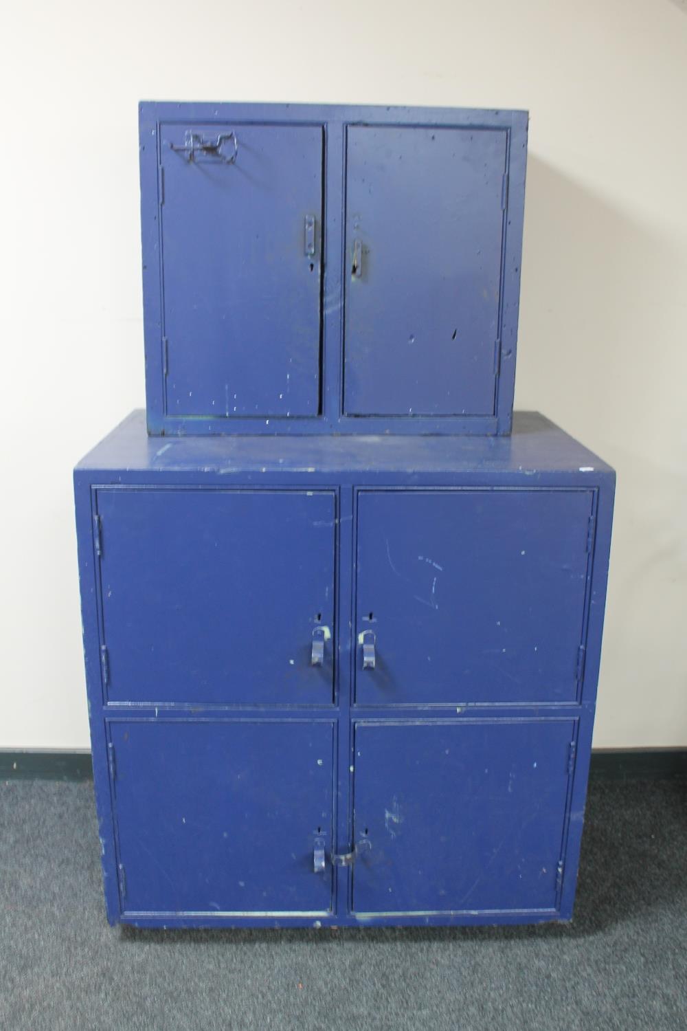 A four door painted engineer's cabinet fitted with drawers together with a double door wall cabinet