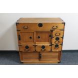 A pine Chinese style cabinet fitted six drawers