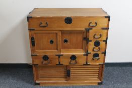 A pine Chinese style cabinet fitted six drawers