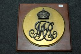 A brass plaque from the Old Crown post office Newcastle upon Tyne, mounted on board.