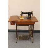 A Singer treadle sewing machine in oak table