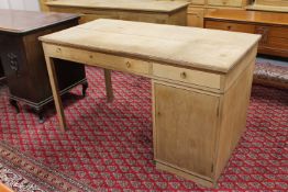 A twentieth century oak single pedestal desk with two drawers