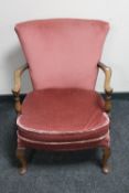 A 20th century beech framed armchair in pink dralon