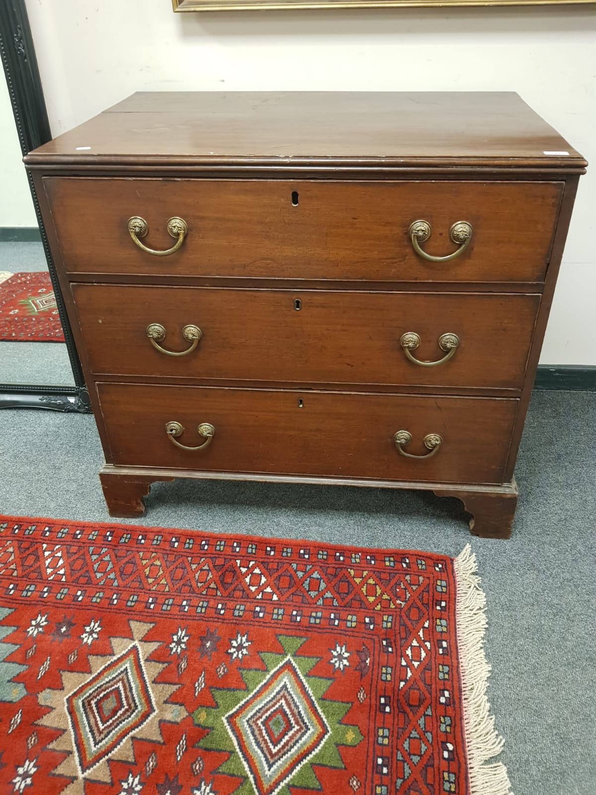 A George III mahogany three drawer chest on bracket feet, width 95 cm.